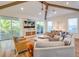 Living room with vaulted ceiling, hardwood floors, and access to a balcony at 9403 Gulf Dr, Anna Maria, FL 34216