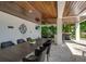 Outdoor dining area with large table and built-in grill at 9403 Gulf Dr, Anna Maria, FL 34216