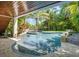 Stunning freeform pool with a spa and tropical backdrop at 9403 Gulf Dr, Anna Maria, FL 34216