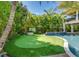 Landscaped putting green adjacent to the pool area at 9403 Gulf Dr, Anna Maria, FL 34216