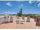 Relaxing rooftop deck with chairs and city views at 9403 Gulf Dr, Anna Maria, FL 34216