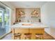 Stylish wet bar with quartz countertop and wood shelving at 9403 Gulf Dr, Anna Maria, FL 34216