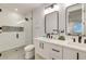 Modern bathroom with double vanity and glass shower at 9407 Gulf Dr, Anna Maria, FL 34216