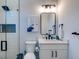 Modern bathroom with walk-in shower and white vanity at 9407 Gulf Dr, Anna Maria, FL 34216