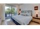 Bedroom with sliding door to balcony and ocean view at 9407 Gulf Dr, Anna Maria, FL 34216