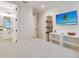 Bedroom with built-in shelves and a large TV at 9407 Gulf Dr, Anna Maria, FL 34216