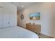 Bedroom with dresser and large wall mounted TV at 9407 Gulf Dr, Anna Maria, FL 34216