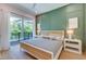 Bedroom with green accent wall and private balcony at 9407 Gulf Dr, Anna Maria, FL 34216