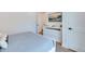 Bright bedroom with white dresser and mounted TV at 9407 Gulf Dr, Anna Maria, FL 34216