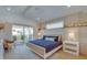 Bright bedroom with a comfortable bed and private balcony access at 9407 Gulf Dr, Anna Maria, FL 34216