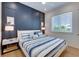 Bedroom with nautical-themed bedding and navy wall at 9407 Gulf Dr, Anna Maria, FL 34216