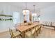 Spacious dining area with a long wooden table and bench seating at 9407 Gulf Dr, Anna Maria, FL 34216