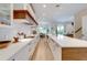 Modern kitchen with white cabinets, quartz countertops, and a large island at 9407 Gulf Dr, Anna Maria, FL 34216