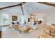 Open living space with hardwood floors, exposed beams, and comfortable seating at 9407 Gulf Dr, Anna Maria, FL 34216