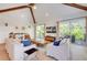 Light-filled living area with sliding doors to a balcony at 9407 Gulf Dr, Anna Maria, FL 34216