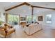 Relaxing living area with hardwood floors, sliding doors, and a large TV at 9407 Gulf Dr, Anna Maria, FL 34216