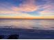 Breathtaking sunset over the ocean with calm waves and soft sands at 9407 Gulf Dr, Anna Maria, FL 34216