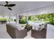 Covered patio overlooks a refreshing pool with lounge chairs at 9407 Gulf Dr, Anna Maria, FL 34216