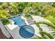 Inviting freeform pool and spa surrounded by lush landscaping at 9407 Gulf Dr, Anna Maria, FL 34216