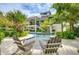 Inviting pool area with lounge chairs, surrounded by tropical landscaping at 9407 Gulf Dr, Anna Maria, FL 34216