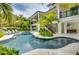 Luxury freeform pool and spa surrounded by lush landscaping at 9407 Gulf Dr, Anna Maria, FL 34216