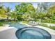 Relaxing pool and spa area with lounge chairs, lush landscaping, and a tranquil atmosphere at 9407 Gulf Dr, Anna Maria, FL 34216