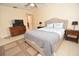 Bright bedroom with a queen-size bed, dresser, and ensuite bathroom access at 1709 Pelican Cove Rd # Gl445, Sarasota, FL 34231