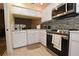 Updated kitchen with stainless steel appliances and mosaic backsplash at 1709 Pelican Cove Rd # Gl445, Sarasota, FL 34231