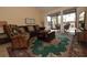 Living room with leather couch and large windows at 1709 Pelican Cove Rd # Gl445, Sarasota, FL 34231