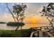 Stunning sunset view from a waterfront deck with seating at 1709 Pelican Cove Rd # Gl445, Sarasota, FL 34231