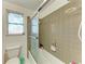 Bathroom showcasing a tiled shower/tub combination and a stained glass window for added decor and privacy at 1777 Pomelo Dr, Venice, FL 34293