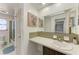 Bathroom featuring a vanity with a large mirror, modern sink and faucet, with a tub/shower in background at 1777 Pomelo Dr, Venice, FL 34293