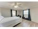 Bedroom with neutral walls, wood floors, white ceiling fan and a double window with privacy blinds at 1777 Pomelo Dr, Venice, FL 34293