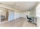 Bonus room with white walls, wood floor and a ceiling fan featuring access to dining area and sliding glass doors at 1777 Pomelo Dr, Venice, FL 34293