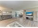 Open concept living room with wood flooring, decorative furniture and decor, with dining area visible in background at 1777 Pomelo Dr, Venice, FL 34293