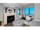Living room with fireplace, water views and comfortable seating at 258 Golden Gate Pt # 801, Sarasota, FL 34236