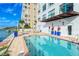 Inviting heated pool with water views and patio seating at 258 Golden Gate Pt # 801, Sarasota, FL 34236