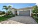 Single-story home with a two-car garage and nicely landscaped front yard at 5433 Hope Sound Cir, Sarasota, FL 34238