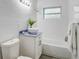 Clean bathroom with white subway tile, a white vanity, and a bathtub at 730 40Th St, Sarasota, FL 34234