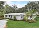 White single story home with landscaped yard and palm trees at 730 40Th St, Sarasota, FL 34234