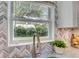 Bright kitchen with stainless steel sink and view of backyard through window at 730 40Th St, Sarasota, FL 34234