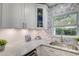 Modern kitchen features white cabinets, granite countertops, and a herringbone backsplash at 730 40Th St, Sarasota, FL 34234