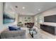 Modern living room with gray couch, glass coffee table, and large TV at 730 40Th St, Sarasota, FL 34234