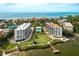 Aerial view of condo community with tennis courts and bay access at 8701 Midnight Pass Rd # 106A, Sarasota, FL 34242