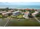Aerial view of waterfront community with multiple buildings, pool, and private docks at 8701 Midnight Pass Rd # 106A, Sarasota, FL 34242