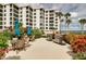 Community grilling area with patio tables and lush landscaping at 8701 Midnight Pass Rd # 106A, Sarasota, FL 34242