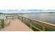 Community dock with seating and tranquil water views at 8701 Midnight Pass Rd # 106A, Sarasota, FL 34242