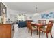Bright dining area with wood table and chairs near the living room at 8701 Midnight Pass Rd # 106A, Sarasota, FL 34242