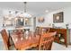 Spacious dining room with wood table and chairs, and views into the kitchen at 8701 Midnight Pass Rd # 106A, Sarasota, FL 34242