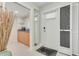 Welcoming entryway with a full-length mirror and storage at 8701 Midnight Pass Rd # 106A, Sarasota, FL 34242
